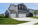 Beautiful two-story home with a three-car garage and well-maintained landscaping at 7153 Sultans Run Ln, Whitestown, IN 46075
