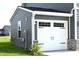 Detached two-car garage featuring a white garage door and gray siding at 7153 Sultans Run Ln, Whitestown, IN 46075