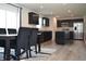 Open-concept kitchen and dining area featuring granite countertops, stainless steel appliances, and a modern island at 7153 Sultans Run Ln, Whitestown, IN 46075