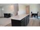 Kitchen with granite countertops and stainless steel appliances leading to living and dining areas at 7153 Sultans Run Ln, Whitestown, IN 46075