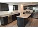 Well-equipped kitchen featuring black cabinets, stainless steel appliances, granite countertops and island at 7153 Sultans Run Ln, Whitestown, IN 46075