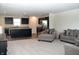 Spacious open layout connects the living room to a kitchen with dark cabinetry and stainless steel appliances at 7153 Sultans Run Ln, Whitestown, IN 46075
