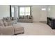 Bright living room with neutral decor, plush carpeting, and a large window for natural light at 7153 Sultans Run Ln, Whitestown, IN 46075