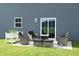 Cozy outdoor patio area with comfortable seating and a sliding glass door at 7153 Sultans Run Ln, Whitestown, IN 46075
