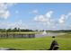 Relaxing view of a pond with a fountain and blue sky at 7153 Sultans Run Ln, Whitestown, IN 46075