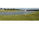 Scenic community pond featuring a fountain and green space in a new construction neighborhood at 7153 Sultans Run Ln, Whitestown, IN 46075