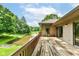 Wooden deck overlooks a stunning pond with a fountain, backing to a tree line at 7175 Scarlet Oak Dr, Noblesville, IN 46062