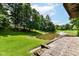 Serene backyard with lush lawn, pond with fountain, and stone patio, perfect for outdoor relaxation at 7175 Scarlet Oak Dr, Noblesville, IN 46062
