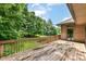 Spacious wood deck overlooking a lush backyard with mature trees and access to the home's brick facade at 7175 Scarlet Oak Dr, Noblesville, IN 46062