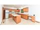 Traditional kitchen with island, oak cabinets, stainless fridge, and adjacent built in desk at 7175 Scarlet Oak Dr, Noblesville, IN 46062