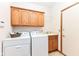 Laundry room with washer, dryer, utility sink, and storage cabinets at 7175 Scarlet Oak Dr, Noblesville, IN 46062