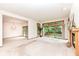 Bright open living room features fireplace, balcony access, and chandelier lighting at 7175 Scarlet Oak Dr, Noblesville, IN 46062