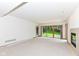 This carpeted living room offers a fireplace and a sliding glass door at 7175 Scarlet Oak Dr, Noblesville, IN 46062