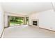 This carpeted living room has a fireplace and a sliding glass door at 7175 Scarlet Oak Dr, Noblesville, IN 46062