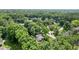 An aerial view reveals a home nestled amongst lush trees, in a quiet residential neighborhood at 7629 Candlewood Ln, Indianapolis, IN 46250