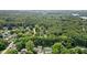 Lush trees and landscaping surround homes in this aerial shot with a lake in the background at 7629 Candlewood Ln, Indianapolis, IN 46250