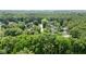 A neighborhood features a mix of tree-lined streets and homes nestled in a lush landscape from above at 7629 Candlewood Ln, Indianapolis, IN 46250
