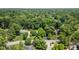 An aerial shot displays homes interspersed with verdant trees in a serene, wooded residential area at 7629 Candlewood Ln, Indianapolis, IN 46250
