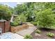 Landscaped backyard featuring a stone pathway, lush greenery, and a charming gazebo, perfect for relaxation at 7629 Candlewood Ln, Indianapolis, IN 46250
