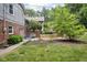 Charming backyard with a patio, bench seating, well-maintained lawn, and beautiful landscaping that offers privacy at 7629 Candlewood Ln, Indianapolis, IN 46250