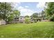 Spacious backyard featuring a well-manicured lawn, mature trees, a gazebo, and a storage shed at 7629 Candlewood Ln, Indianapolis, IN 46250