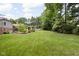 Large backyard with expansive lawn, bordered by trees and shrubbery that offers plenty of space and privacy at 7629 Candlewood Ln, Indianapolis, IN 46250