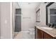 Bathroom featuring a stone shower and a dark wood vanity with marble countertop at 7629 Candlewood Ln, Indianapolis, IN 46250