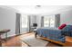 Bright bedroom with hardwood floors and natural light from dual windows at 7629 Candlewood Ln, Indianapolis, IN 46250