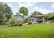 Lush backyard with a gazebo, mature trees and a well-maintained lawn, enhancing the home's curb appeal at 7629 Candlewood Ln, Indianapolis, IN 46250