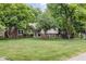 This charming home has a large manicured lawn and mature trees at 7629 Candlewood Ln, Indianapolis, IN 46250