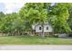 Charming two-story home with landscaped yard and mature trees at 7629 Candlewood Ln, Indianapolis, IN 46250