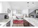 Bright kitchen featuring a cozy breakfast nook and a brick fireplace at 7629 Candlewood Ln, Indianapolis, IN 46250