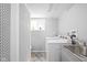 Bright laundry room equipped with modern appliances and ample counter space at 7629 Candlewood Ln, Indianapolis, IN 46250