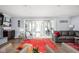 Cozy living room with large windows, a fireplace, and comfortable seating at 7629 Candlewood Ln, Indianapolis, IN 46250