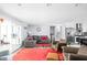 Open-concept living room with large windows and stainless steel appliances in kitchen at 7629 Candlewood Ln, Indianapolis, IN 46250