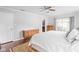 Serene main bedroom with hardwood floors, dresser, and a sliding glass door at 7629 Candlewood Ln, Indianapolis, IN 46250
