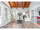 Well-lit sunroom with wood ceiling, gym equipment and view of outdoors at 7629 Candlewood Ln, Indianapolis, IN 46250