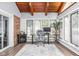 Relaxing sunroom featuring a desk, wood ceiling, and backyard views at 7629 Candlewood Ln, Indianapolis, IN 46250