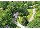 Aerial shot of home with driveway, lawn, and surrounded by trees at 7736 Wawasee Dr, Indianapolis, IN 46250