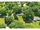 Home surrounded by lush trees and landscaping in peaceful neighborhood at 7736 Wawasee Dr, Indianapolis, IN 46250