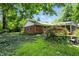 Picturesque backyard with a well-maintained brick house, a decorative tree, and flourishing ground cover at 7736 Wawasee Dr, Indianapolis, IN 46250