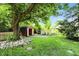 Landscaped backyard with a storage shed and rocks at 7736 Wawasee Dr, Indianapolis, IN 46250