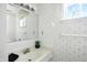 Bathroom featuring a vanity, mirror, and patterned wallpaper at 7736 Wawasee Dr, Indianapolis, IN 46250