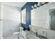 Bright bathroom featuring a modern sink, a large mirror, and a window for natural light at 7736 Wawasee Dr, Indianapolis, IN 46250