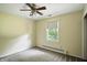 Bedroom with neutral walls, carpet, a ceiling fan, and a window at 7736 Wawasee Dr, Indianapolis, IN 46250
