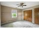 Bedroom featuring a ceiling fan, neutral walls, carpet, a window, and a closet at 7736 Wawasee Dr, Indianapolis, IN 46250