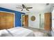 Bedroom features a ceiling fan, neutral carpeting, and two large closets with paneled doors at 7736 Wawasee Dr, Indianapolis, IN 46250