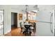 Cozy dining area features a round table, hardwood floors, and unique blue pendant lighting at 7736 Wawasee Dr, Indianapolis, IN 46250