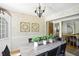 Traditional dining room with chandelier lighting and an open doorway leading to living room at 7736 Wawasee Dr, Indianapolis, IN 46250