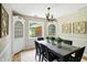 Traditional dining room featuring built-in cabinets, a chandelier, and views to the outside at 7736 Wawasee Dr, Indianapolis, IN 46250